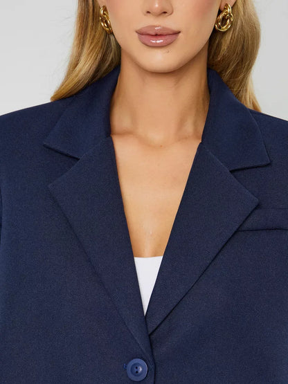 Close-up of a model wearing the Lauven Marine Blazer, a women’s navy cropped oversized jacket.