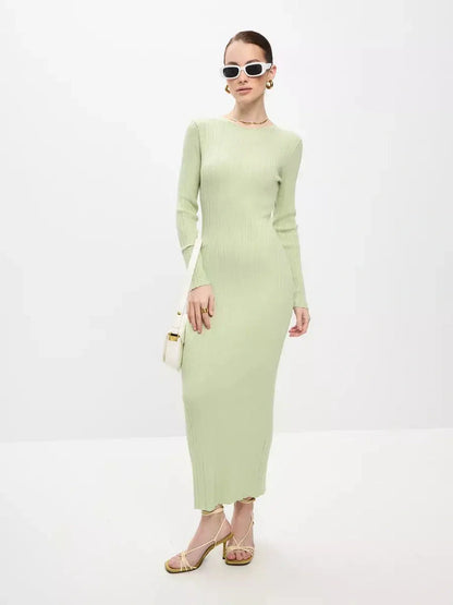 Model wearing a light green ribbed Celery Luxe Maxi Dress, showcasing seamless elegance and sculpted fit with stylish accessories.