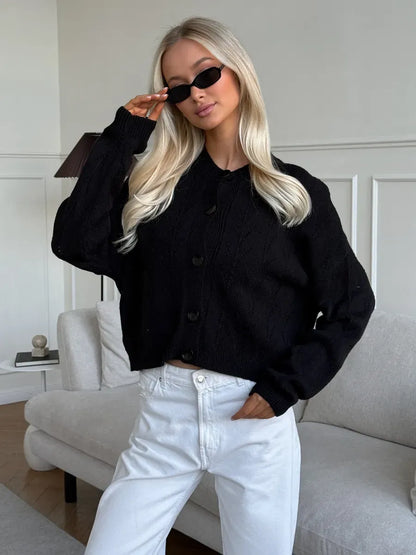 Model wearing Onyx Cardigan by Lauven, a stylish button-up knit with soft textured fabric.