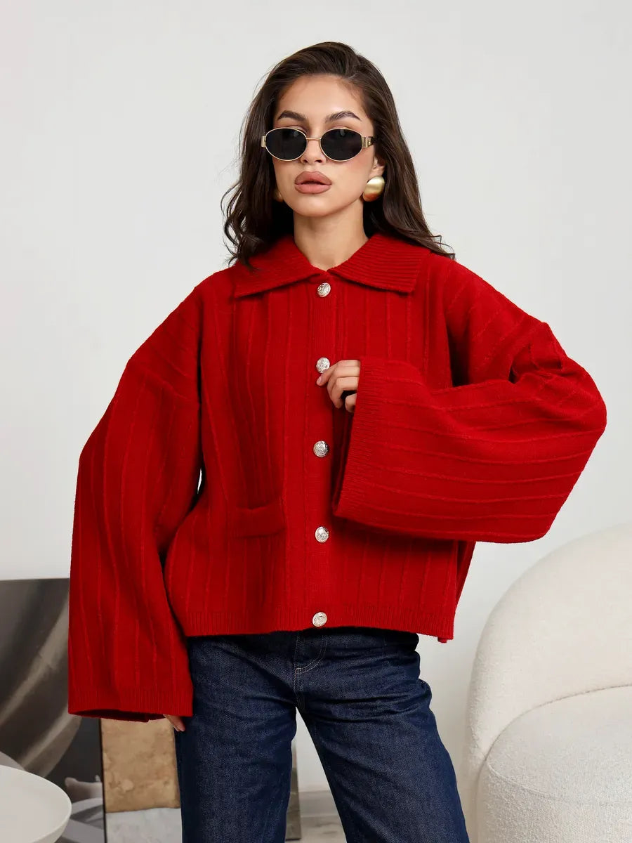 Stylish woman wearing a Crimson Cardigan from Lauven with oversized sleeves and button details.