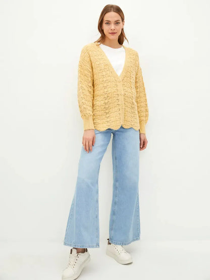 Solenne Cardigan by Lauven, a textured knit cardigan in warm yellow, styled with relaxed elegance and casual jeans.
