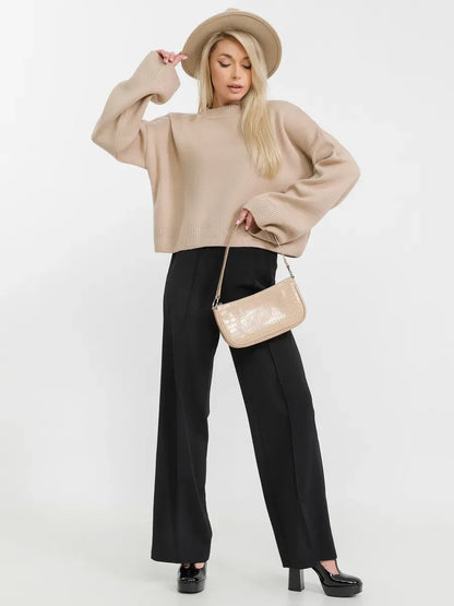 Siena Sweater by Lauven in beige knitwear, paired with chic black pants and stylish accessories.