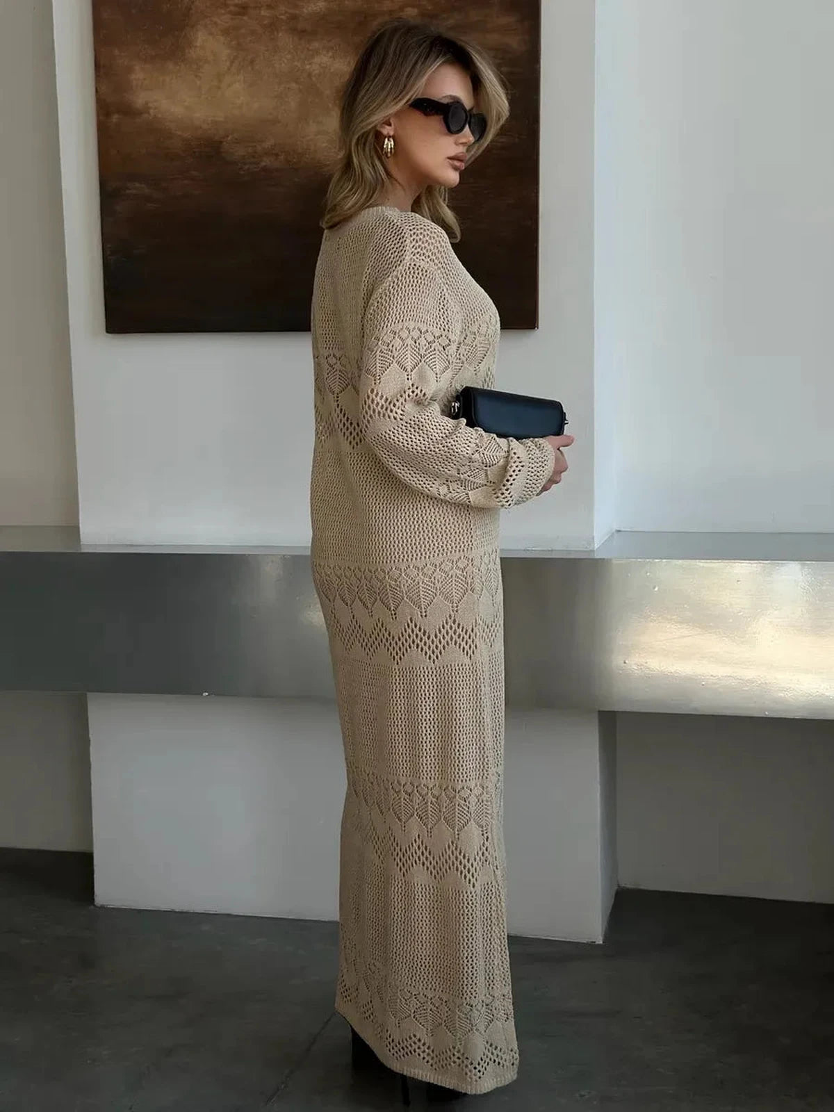 Model wearing the Verona Maxi Dress by Lauven, showcasing its elegant beige crochet knit design.