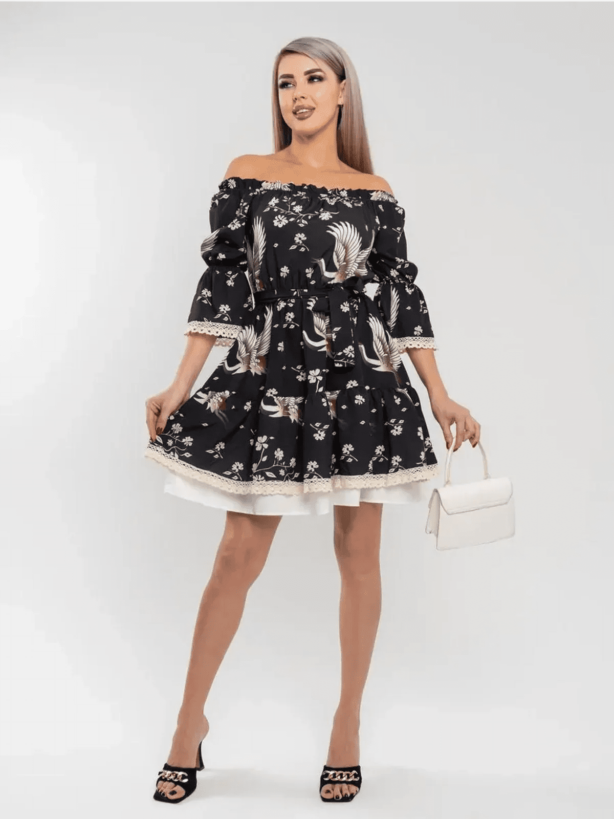 Off-shoulder Crane Bloom mini dress featuring tiered skirt and floral print, perfect for stylish, romantic occasions.