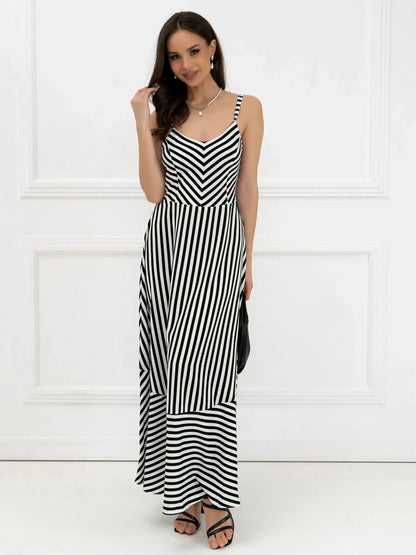 Model wearing a black and white striped maxi dress with a fitted bodice and A-line silhouette.