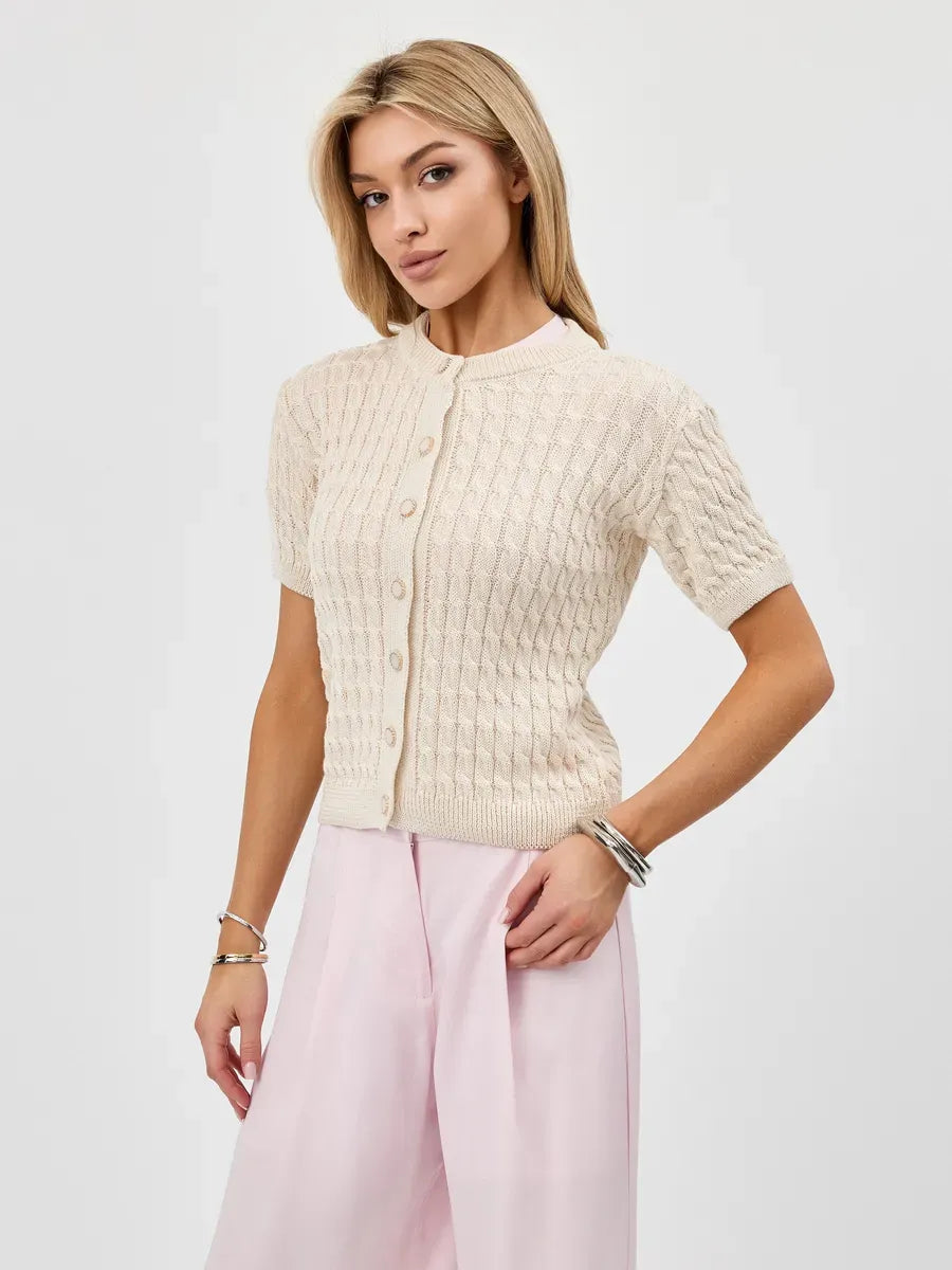 Elegant woman wearing the Lumiere Cardigan by Lauven, showcasing lightweight cotton-acrylic knitwear.