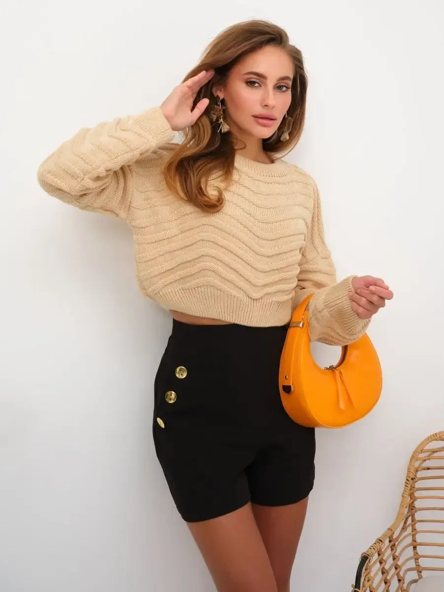 Florence Sweater by Lauven in light beige textured knit, styled with black shorts and an orange handbag.