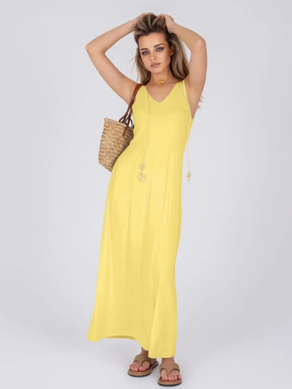 Woman wearing Solara Maxi Dress by Lauven, a bright yellow ribbed knit dress perfect for summer elegance.