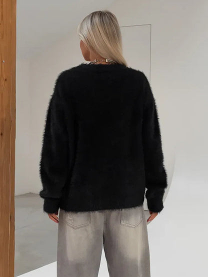 Nyx Cardigan from Lauven, oversized black fluffy knit, back view showcasing relaxed silhouette and warm texture.
