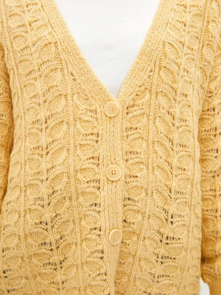Solenne Cardigan by Lauven in warm yellow with textured jacquard pattern and V-neckline for relaxed elegance.