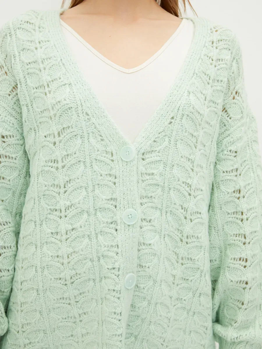 Celestia Cardigan by Lauven in soft green, featuring a delicate jacquard knit pattern and V-neckline.