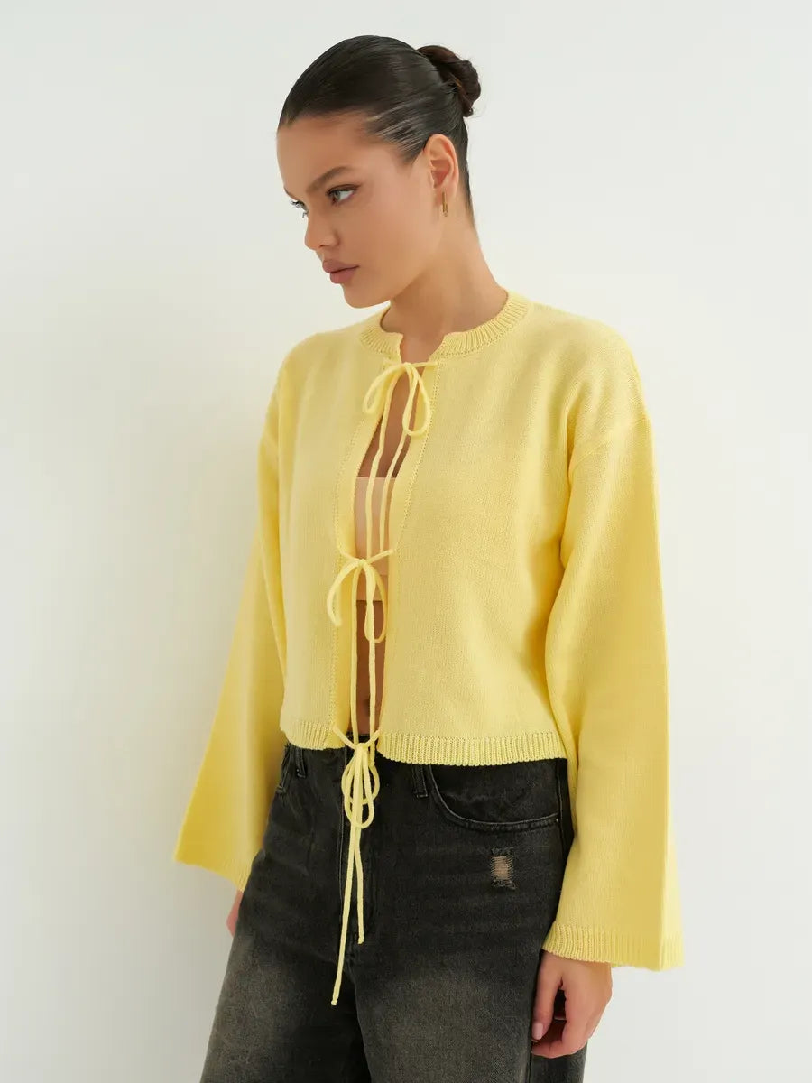 Solara Cardigan by Lauven, a cropped yellow knit with tie-front detailing for summer layering.