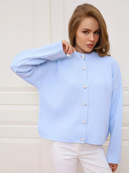 Celeste Cardigan by Lauven in light blue knit with pearl button closure, perfect for spring and summer styling.