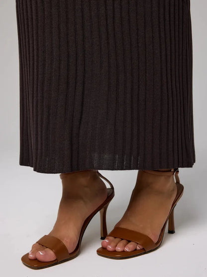 Cacao Maxi Dress detail featuring chic brown ribbed knit fabric and stylish brown heeled sandals.