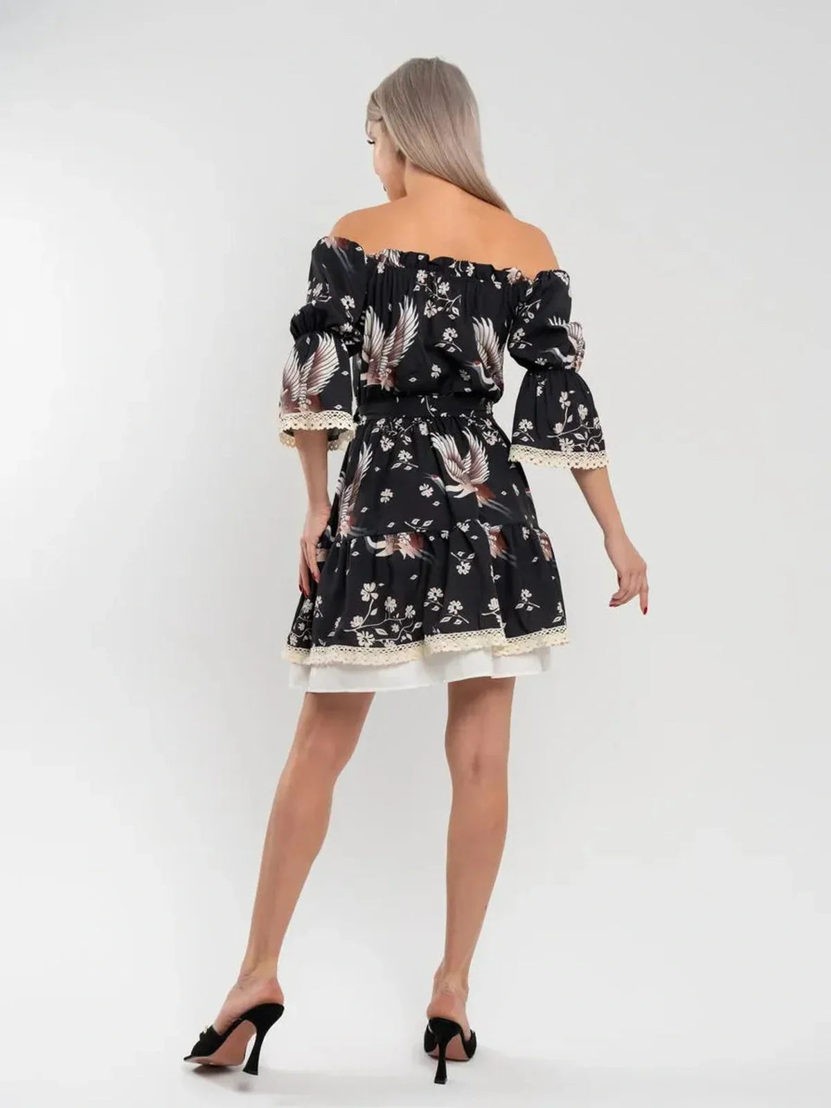Back view of the off-shoulder Crane Bloom mini dress with floral print and A-line silhouette.