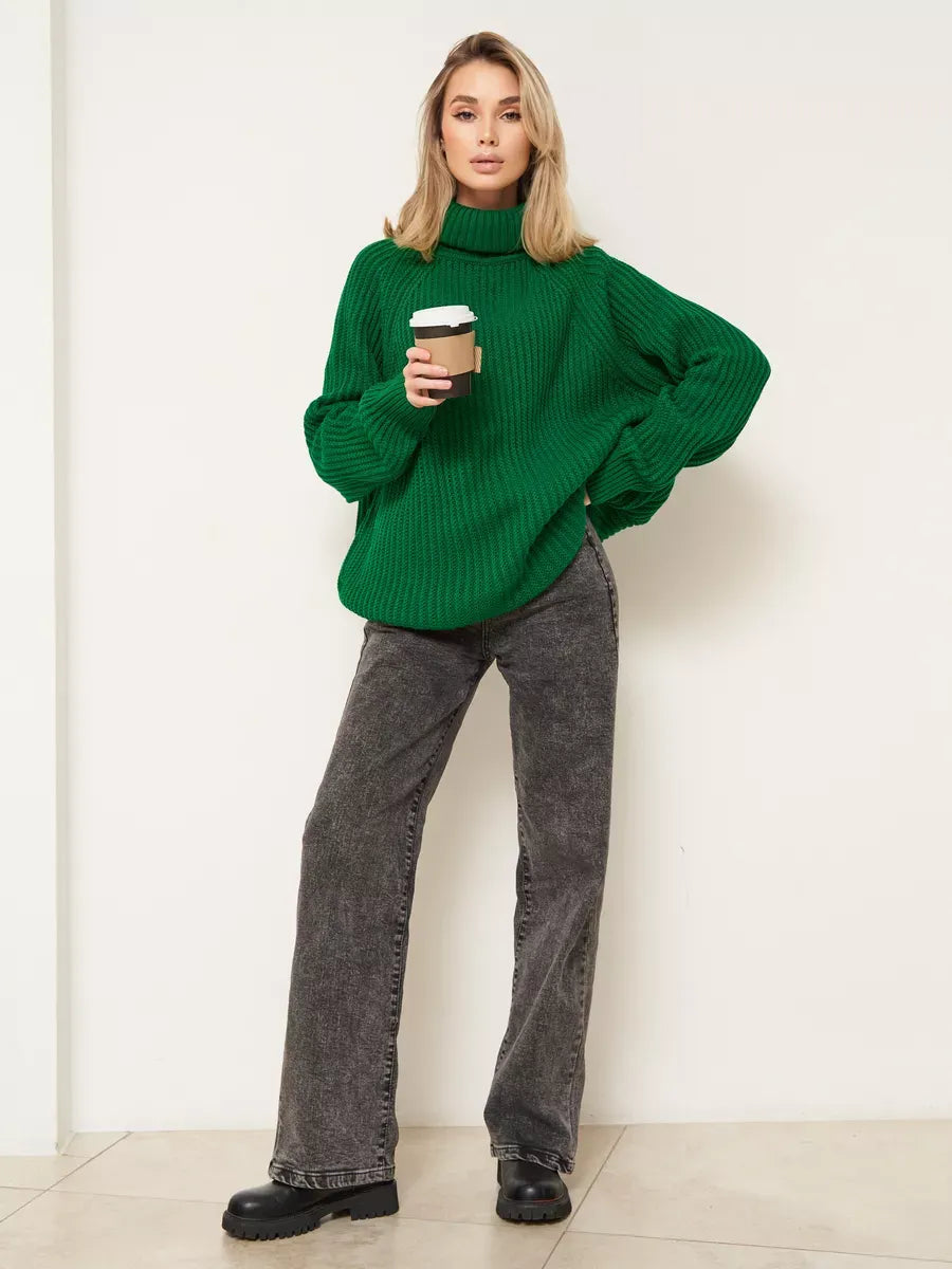 Emerald Sweater by Lauven, oversized green knitwear with turtleneck, worn with gray jeans and holding coffee.