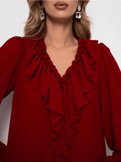 Close-up of the neckline of the Marsella Mini Dress by Lauven, featuring elegant ruffle detailing in wine-red chiffon.