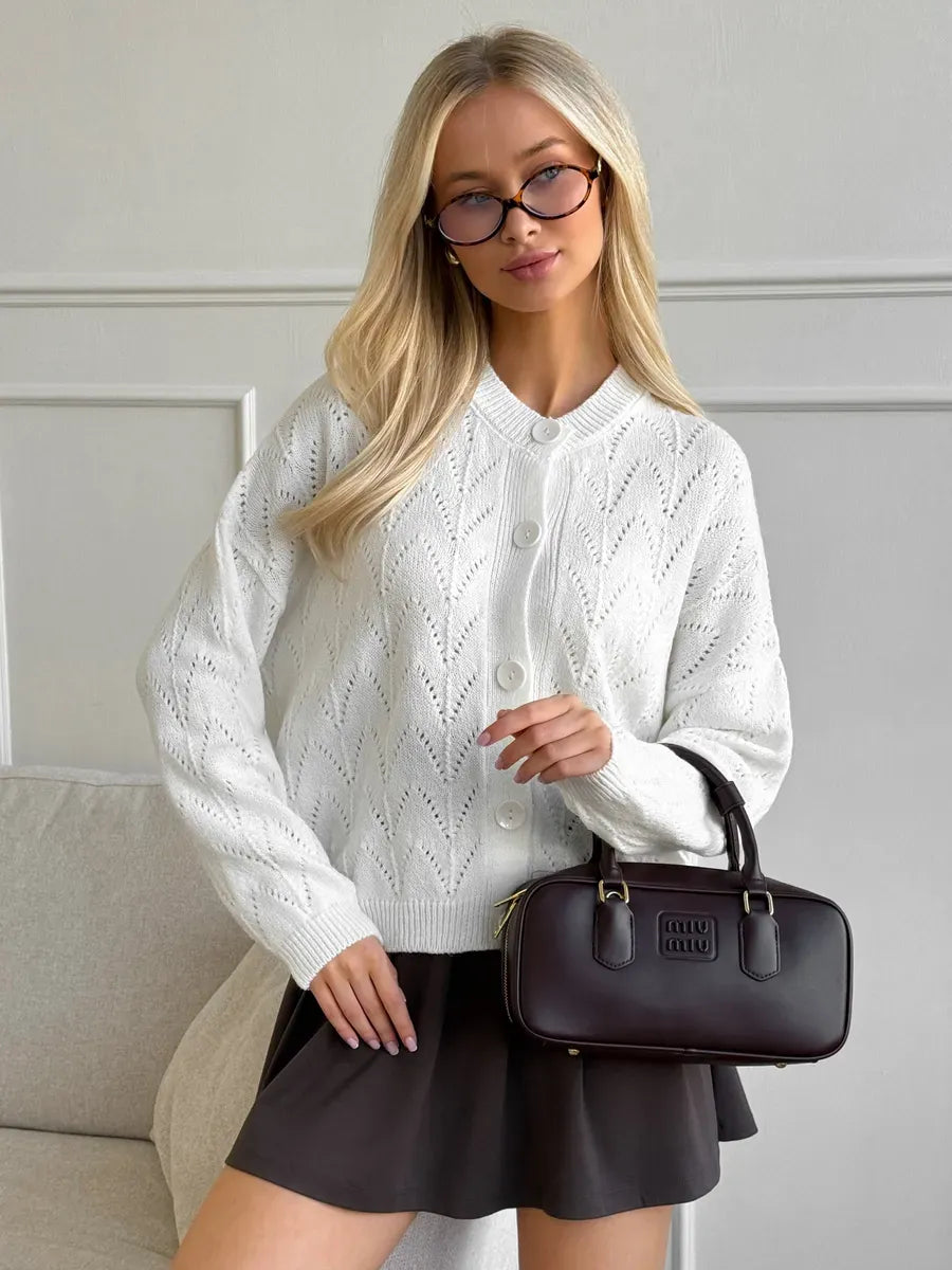 Ivory Cardigan by Lauven featuring a lightweight knit design with delicate lace pattern, styled with a black skirt.