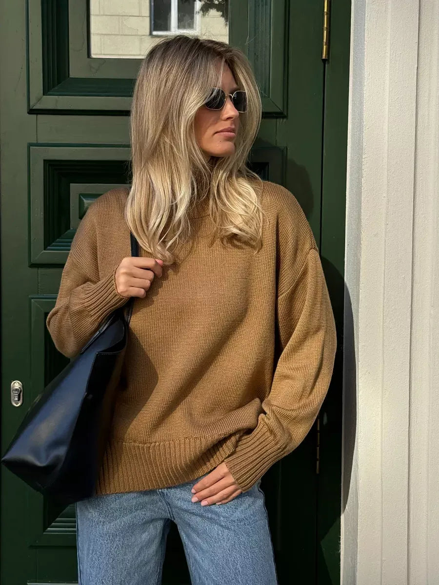 Oversized Marlo Sweater by Lauven in camel color with asymmetric hem, worn casually with sunglasses.