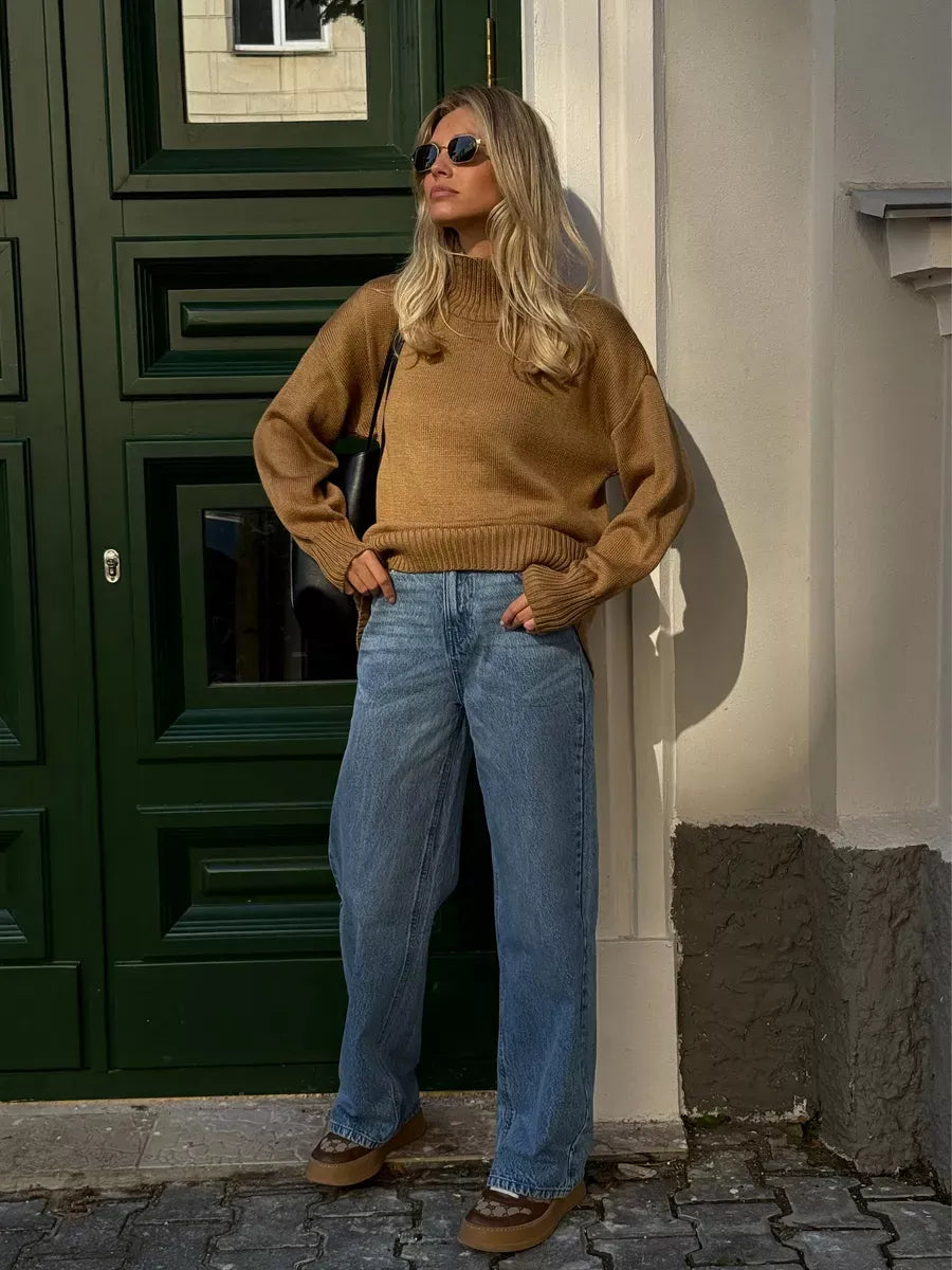 Marlo Sweater by Lauven in camel, oversized knit with asymmetric hem, styled with wide jeans and sunglasses.