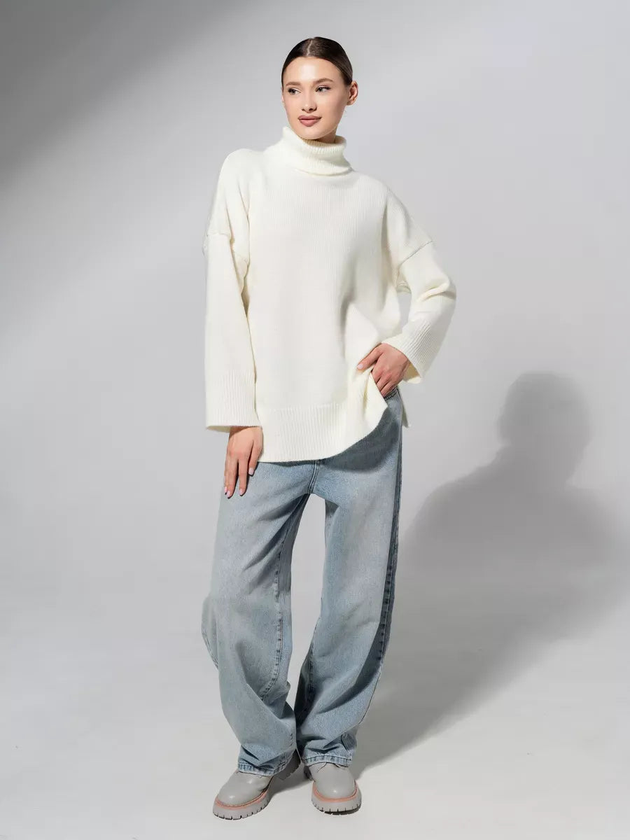 Woman wearing Luna Sweater by Lauven, oversized knit in soft milk white, paired with relaxed-fit jeans.