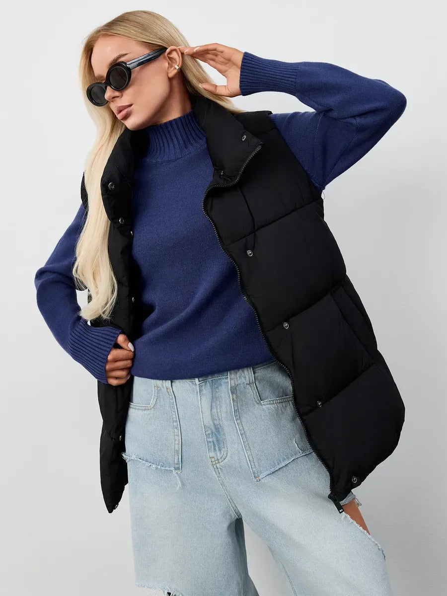 Woman wearing an Indigo Sweater by Lauven, styled with a black puffer vest and high-fashion sunglasses.