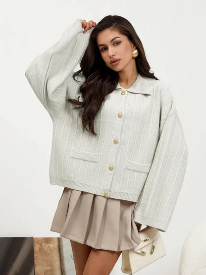 Model wearing Lauven Glacier Cardigan, a chic light gray oversized knitwear with braided detail and wide bell sleeves.