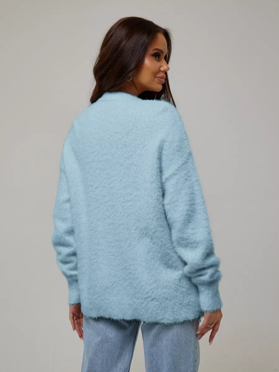 Back view of a model wearing the Skyler Cardigan by Lauven in soft blue oversized knitwear.