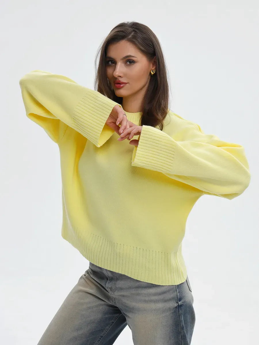 Stylish model wearing the Solara Sweater by Lauven in light yellow, showcasing oversized knit fashion.