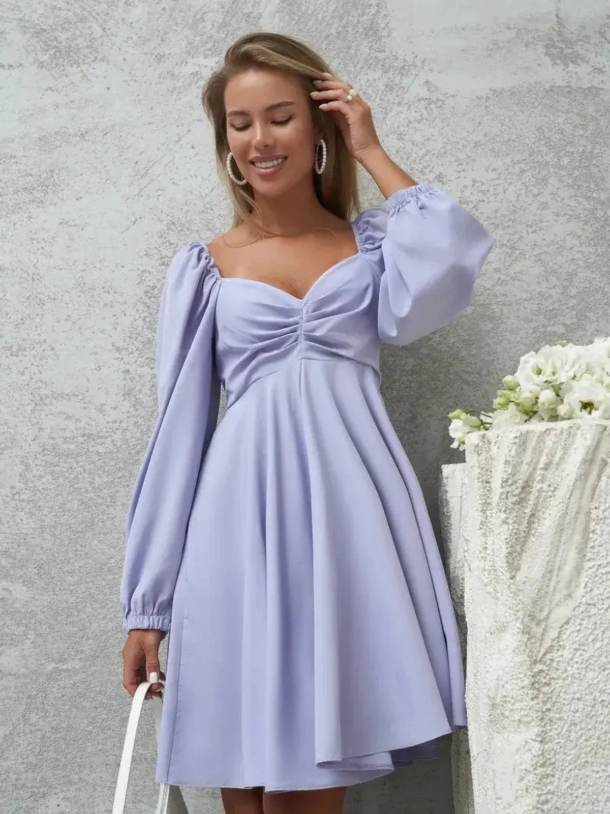 Elegant lilac mini dress with voluminous sleeves and a V-neckline, perfect for any occasion.