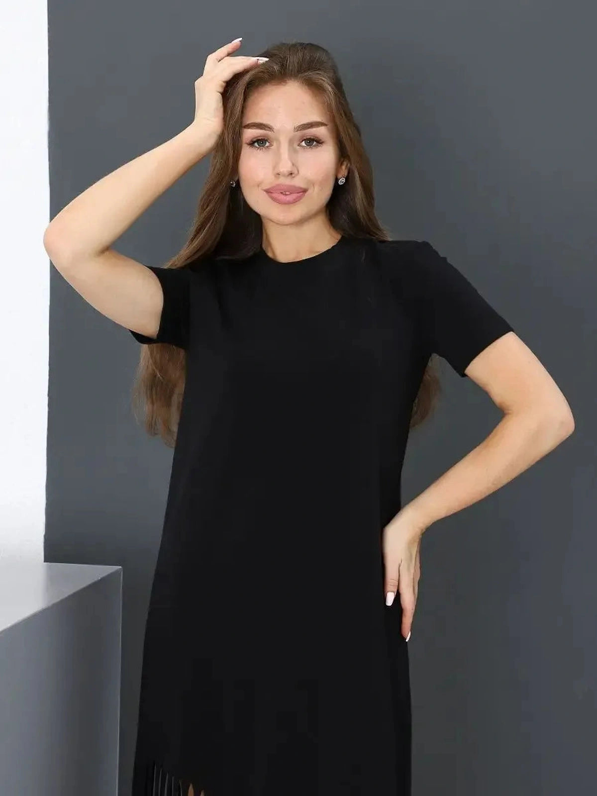 Noir Midi Dress by Lauven featuring a model showcasing a black cotton dress with fringe hem.