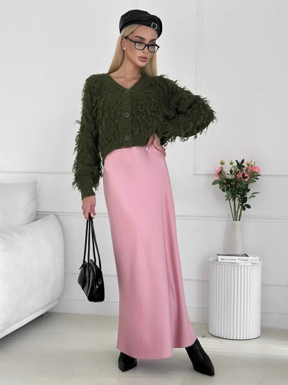 Olive Cardigan by Lauven, cropped oversized khaki bouclé knit with feathered fringe, styled with a pink skirt.