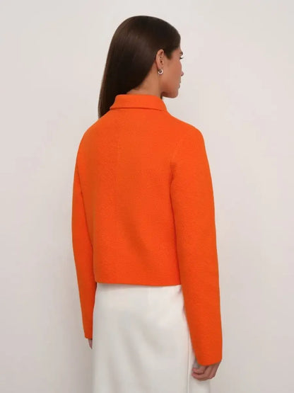 Back view of a woman wearing a Lauven Coral Jacket in vibrant orange with a cropped fit.