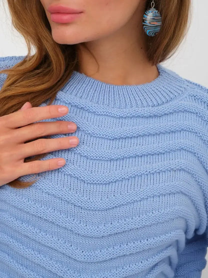 Close-up of the Celeste Sweater in sky blue, featuring a textured wave-knit pattern, by Lauven.