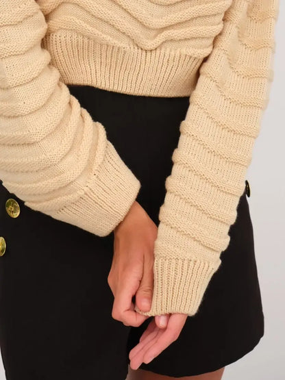 Close-up of the cozy light beige Florence Sweater by Lauven, featuring textured knit and relaxed fit.