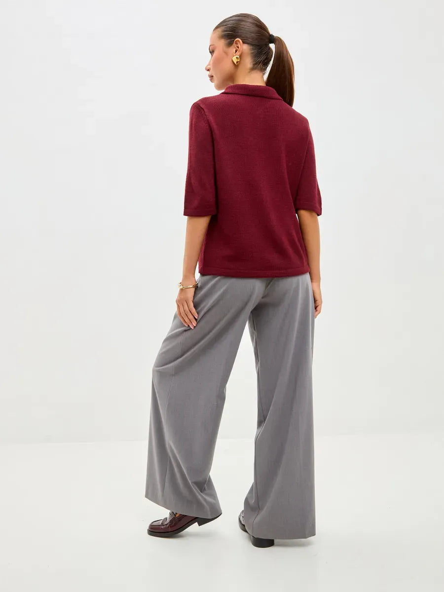 Model wearing the Mira Cardigan by Lauven, showcasing the burgundy wool blend knitwear from the back.