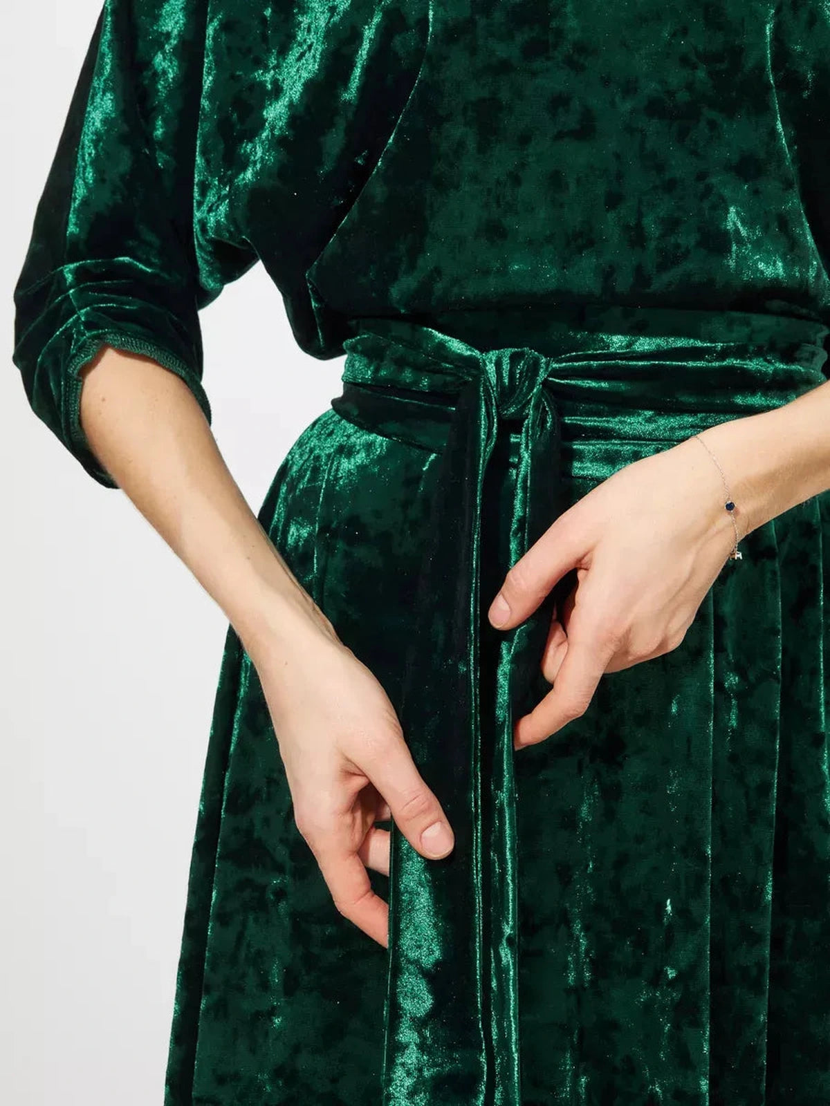 Close-up of Lauven Emerelle Maxi Dress in emerald green velvet featuring a tied waist and elegant texture.