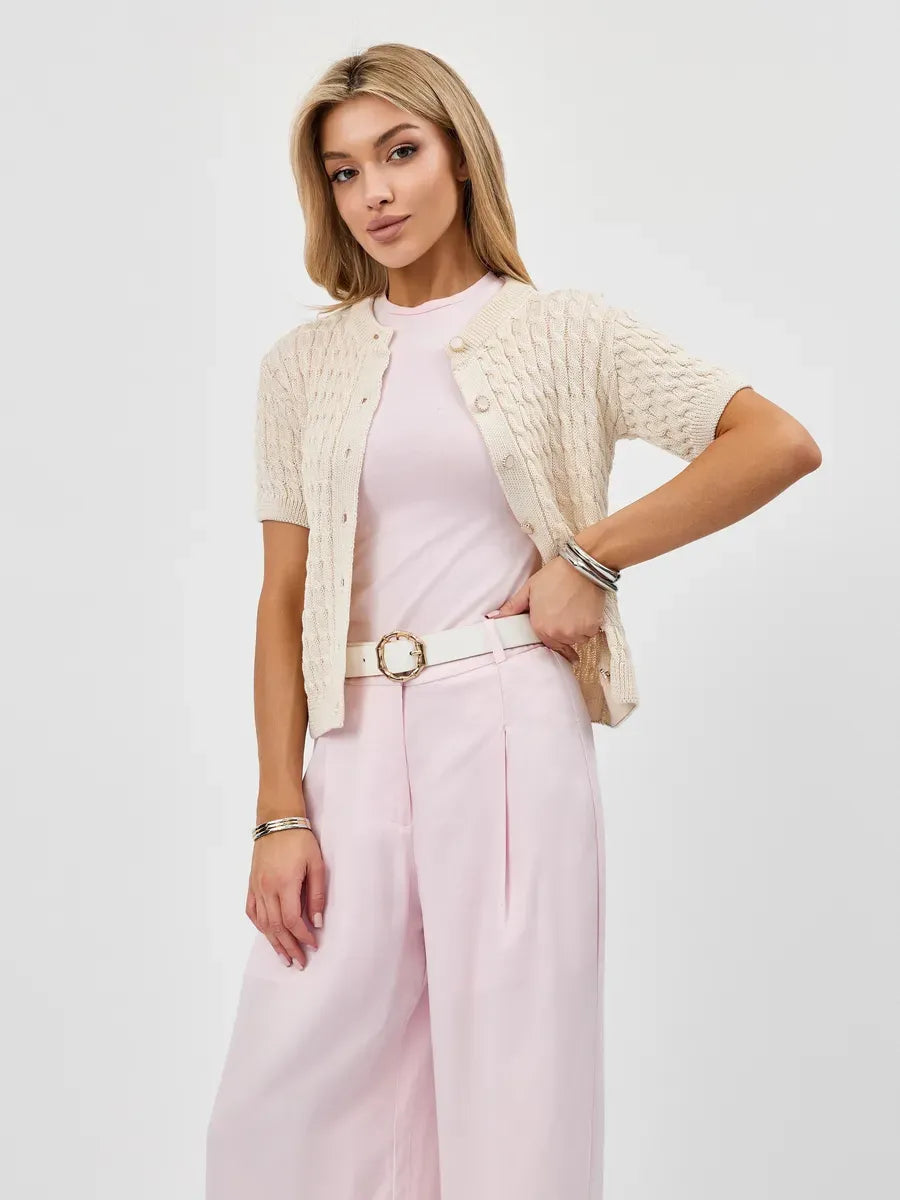 A model showcasing the Lauven Lumiere Cardigan, a lightweight cotton-acrylic knitwear, styled with pastel-colored outfit.