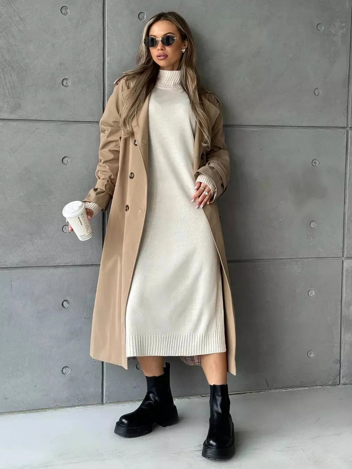 Celeste Midi Dress by Lauven, featuring a soft beige knit design styled with a trench coat and bold black boots.