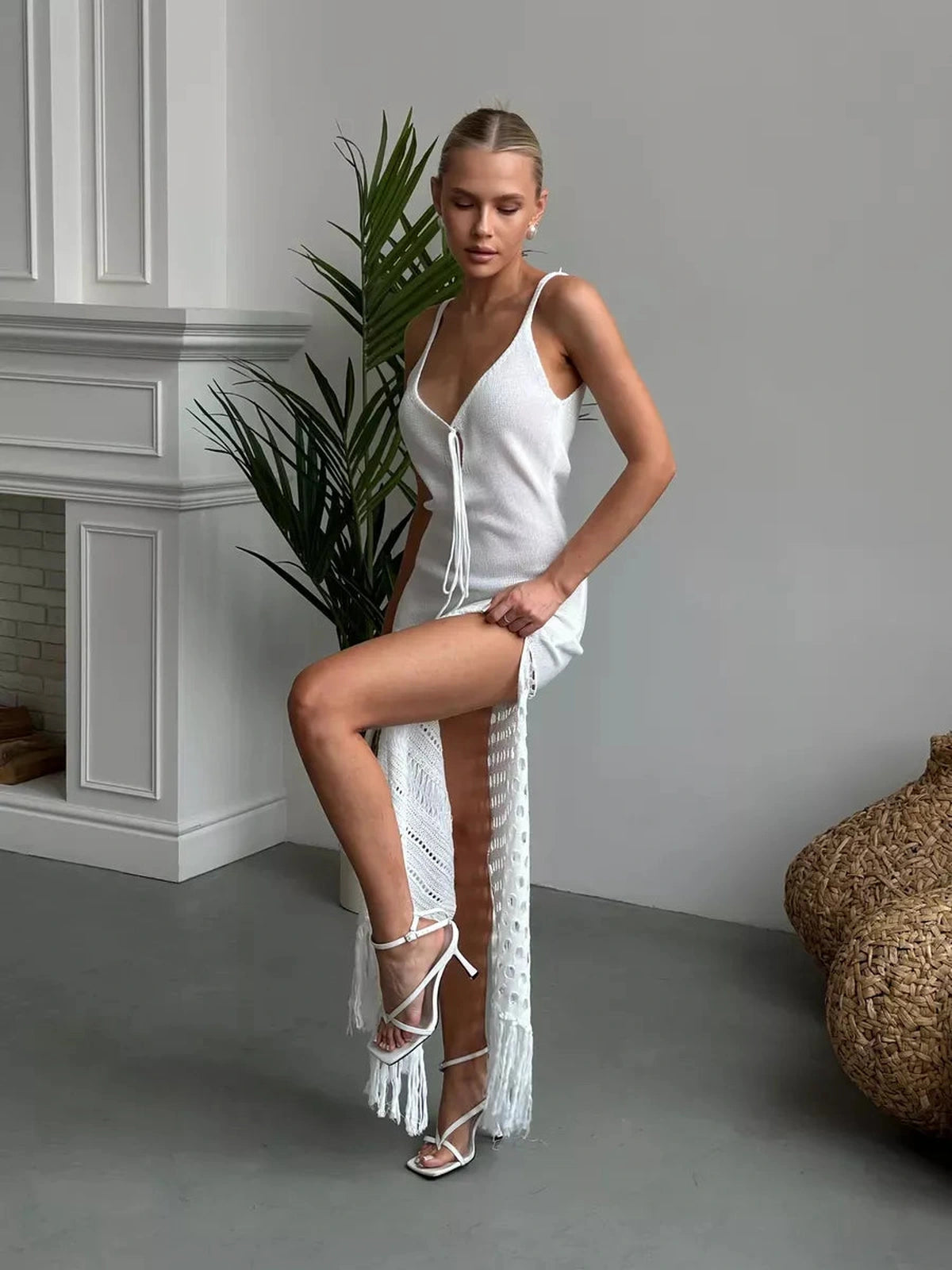 Model showcasing the Solara Maxi Dress by Lauven, featuring airy knit details and a side slit for elegant summer styling.