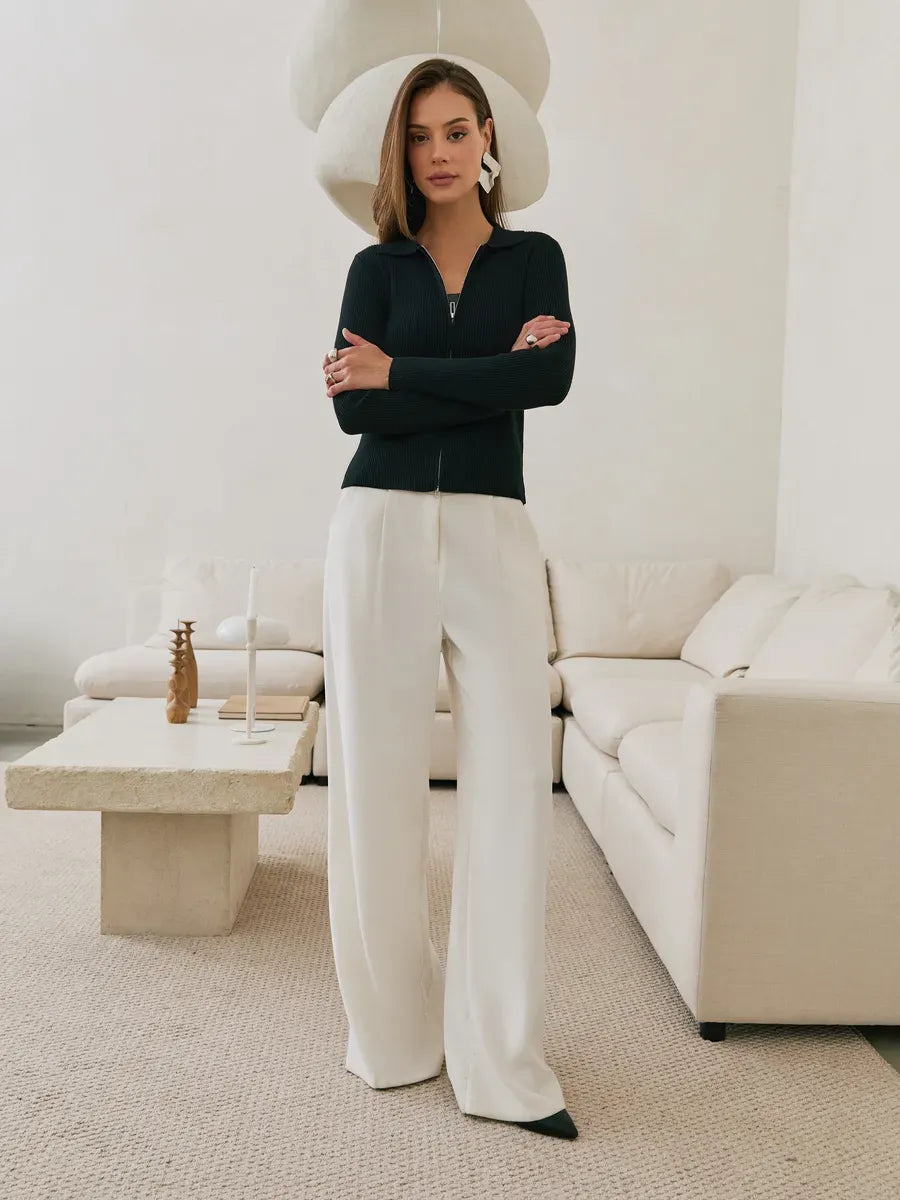 Nova Cardigan by Lauven - Black ribbed knit with two-way zipper, styled with chic white trousers.
