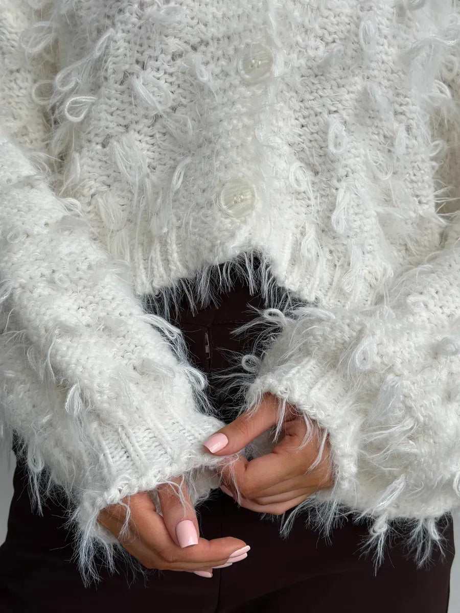 Ivory Cardigan by Lauven featuring cozy cropped design with feathered fringe and button closures.