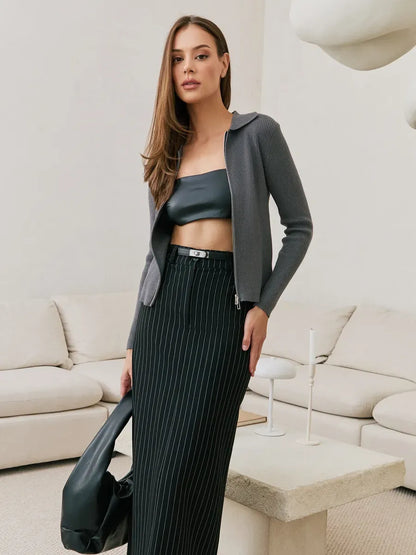 Orion Cardigan by Lauven in dark gray ribbed knit with two-way zipper, styled with sleek pants.