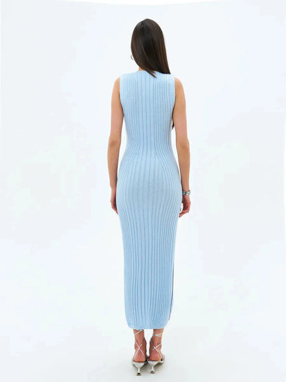 Back view of a model wearing the Celeste Midi Dress by Lauven in soft blue ribbed knit fabric.