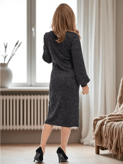 Noir Midi Dress by Lauven showcasing a woman in a graphite black knit dress from the back, highlighting its elegant fit.