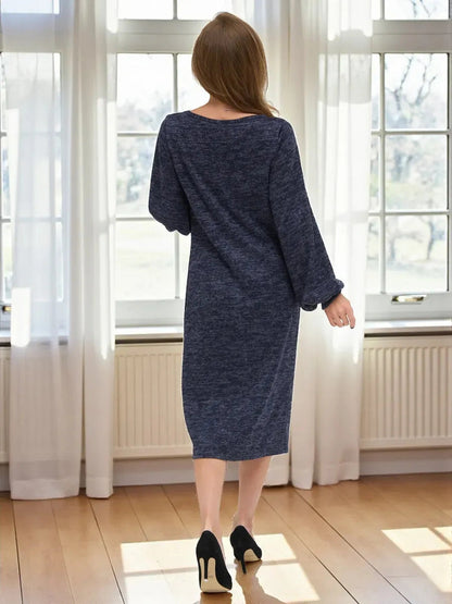 Woman wearing Celeste Midi Dress by Lauven, showcasing elegant knit design and balloon sleeves in deep navy melange.