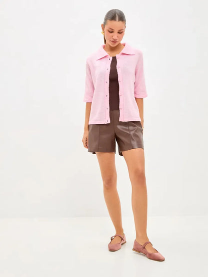 Vera Cardigan by Lauven in lightweight pink wool blend, styled with brown shorts and casual shoes.