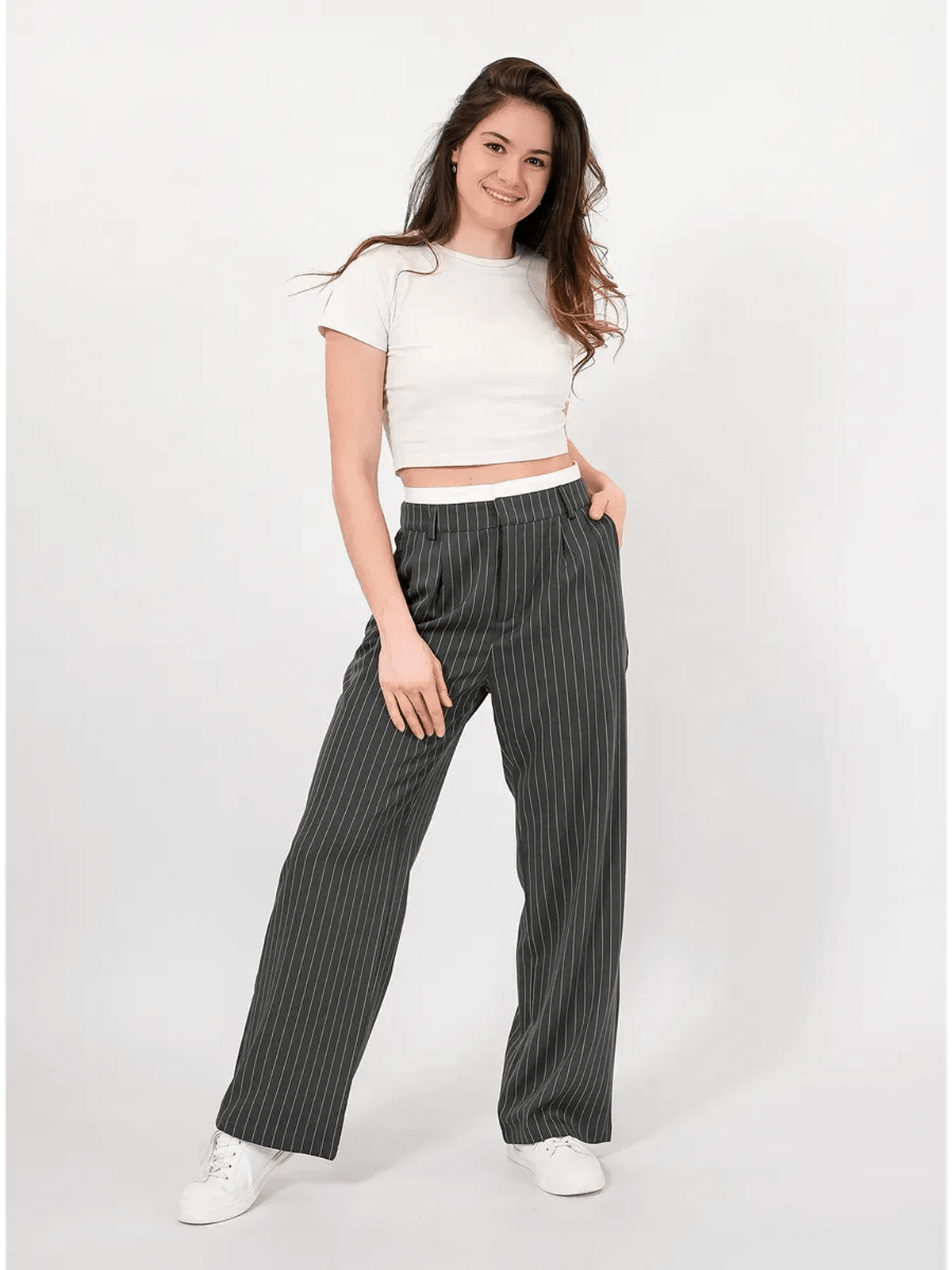 Model wearing elegant Luna Pants by Lauven, featuring a high-waist and subtle pinstripe pattern.