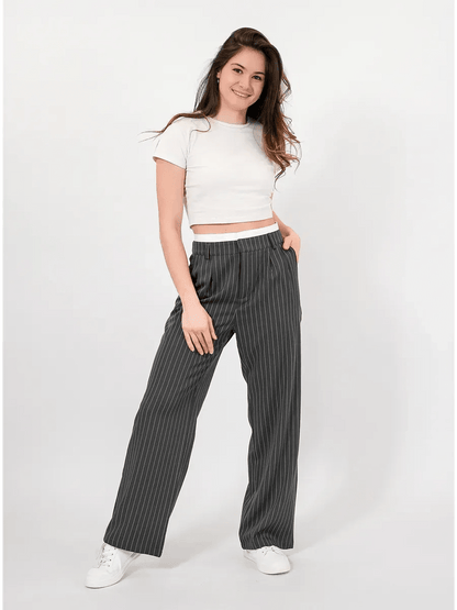 Model wearing elegant Luna Pants by Lauven, featuring a high-waist and subtle pinstripe pattern.
