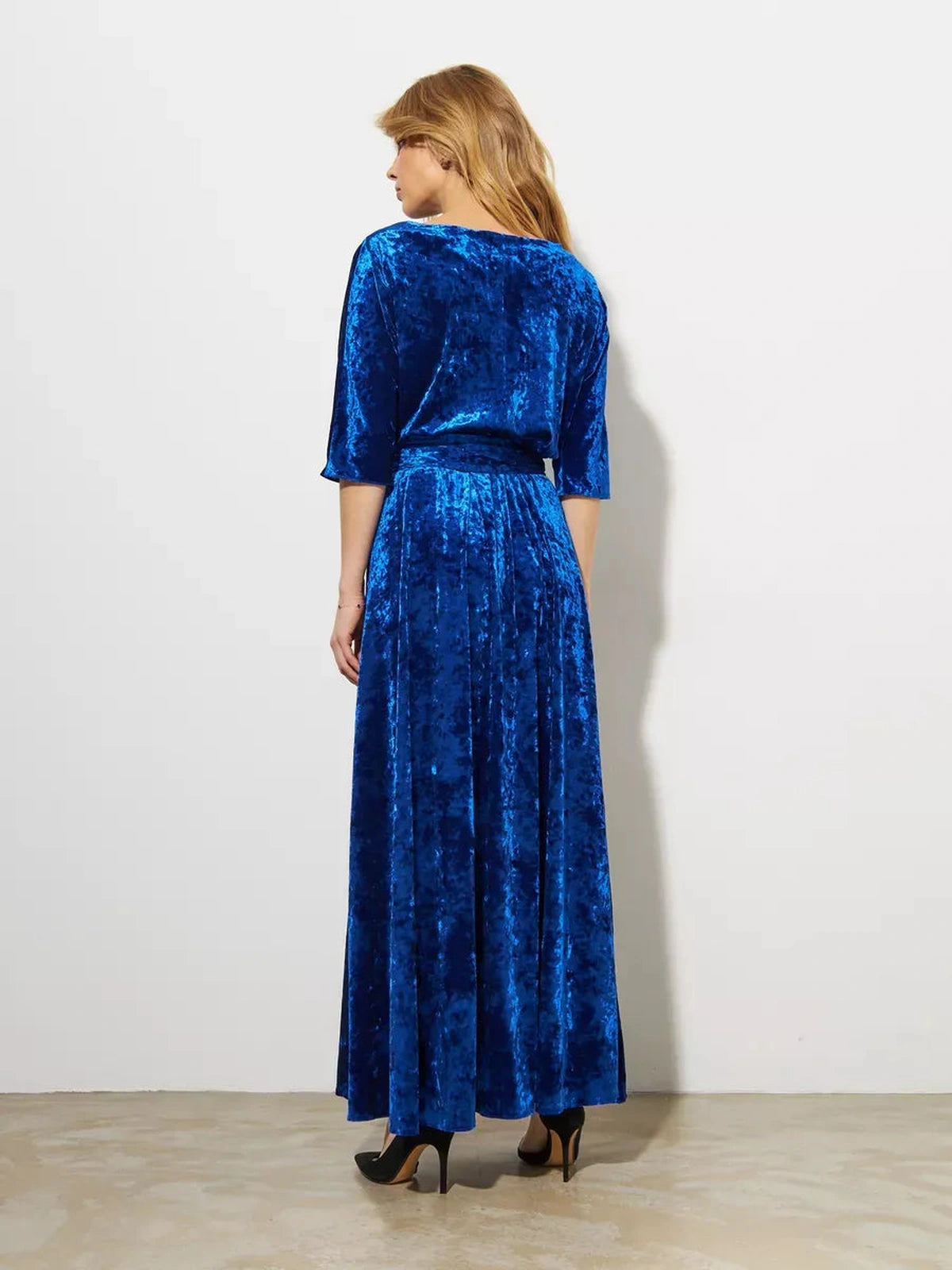 Celestia Maxi Dress by Lauven, back view showcasing the elegant velvet A-line silhouette in sapphire blue.